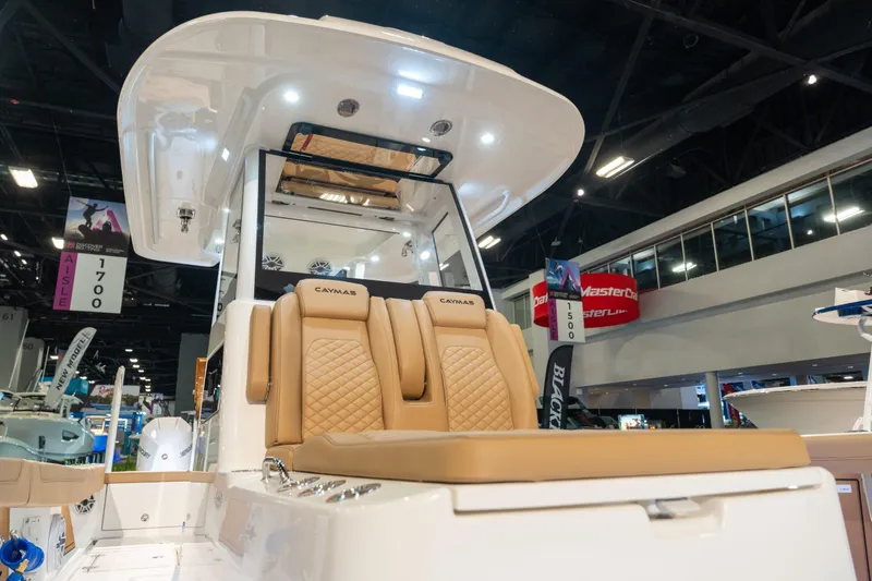 Slide: The Image of 2027 Caymas 29 CT boat with luxurious seating at a trade show. - 11