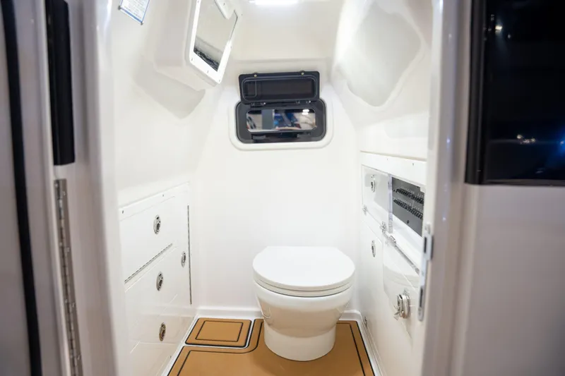 Slide: The Image of Interior of 2027 Caymas 29 CT featuring toilet and storage. - 13