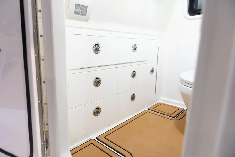 Slide: The Image of Interior of 2027 Caymas 29 CT featuring drawers and toilet. - 15