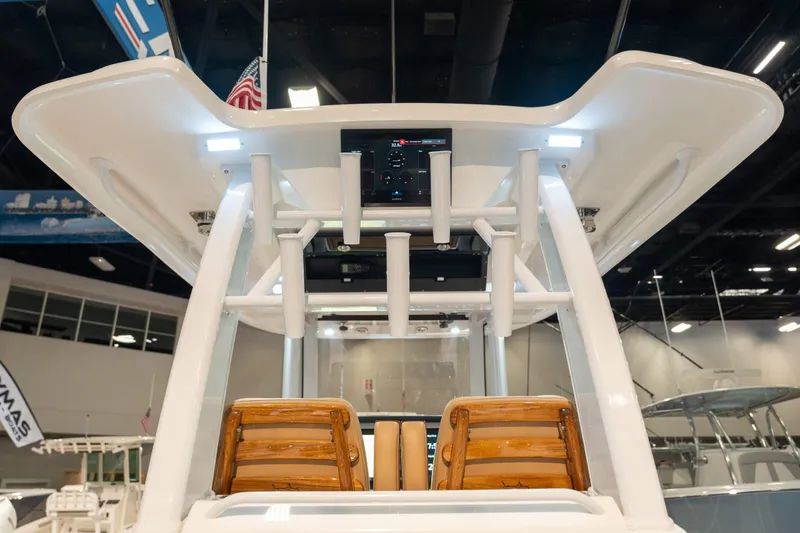 Slide: The Image of Caymas 29 CT 2027 featuring modern helm console and wooden accents. - 18