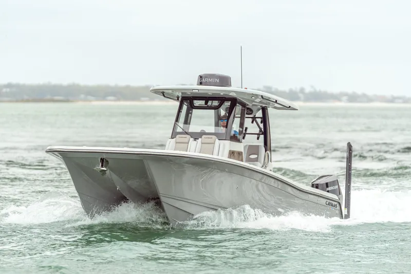 Slide: The Image of 2027 Caymas 29 CT boat cruising on water. - 2