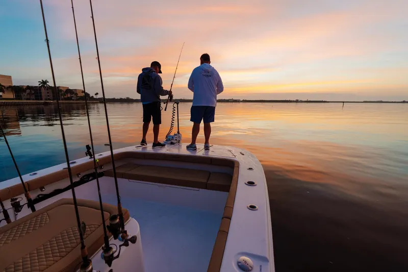 Slide: The Image of Two anglers on a Caymas 29 CT boat at sunset. - 23