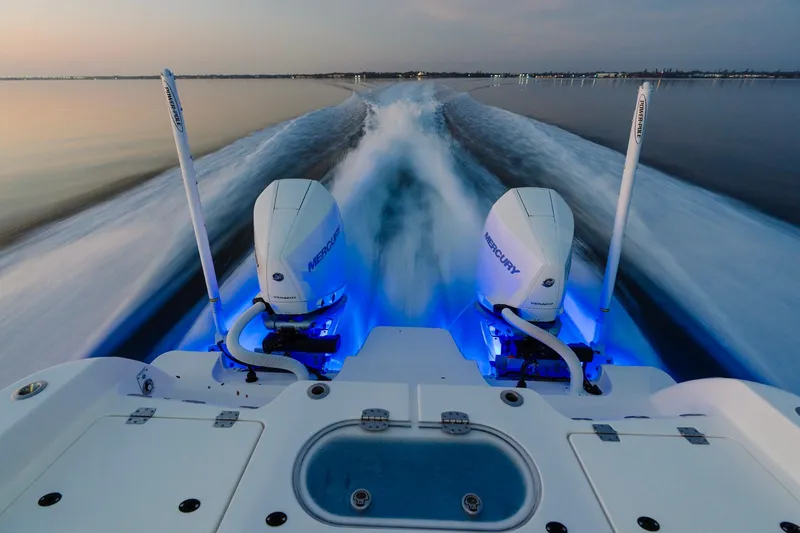Slide: The Image of Caymas 29 CT 2027 boat with dual Mercury engines on calm water. - 5