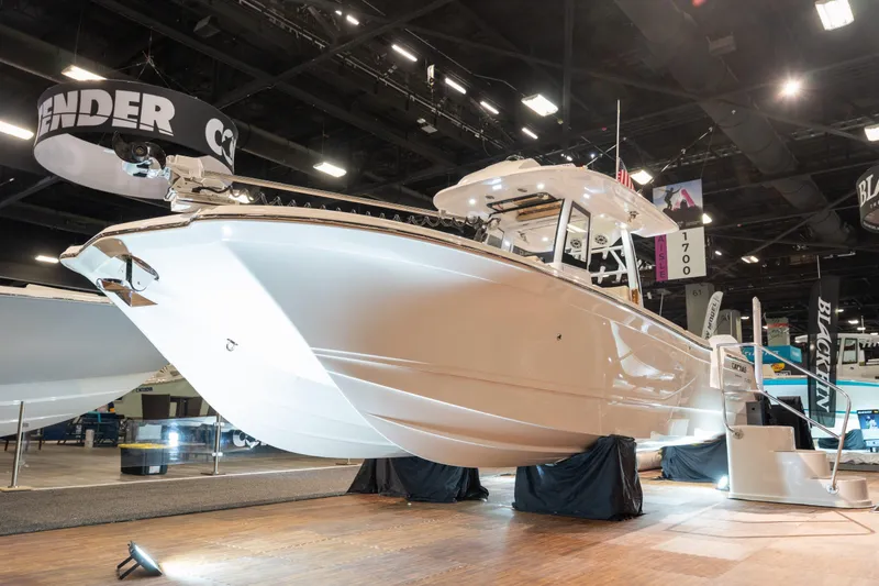 Slide: The Image of Caymas 29 CT 2027 boat displayed at a trade show. - 7