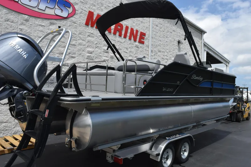 Slide: The Image of 2026 Bentley Pontoons Legacy 243 Swingback with Yamaha engine on trailer at marine dealership. - 4