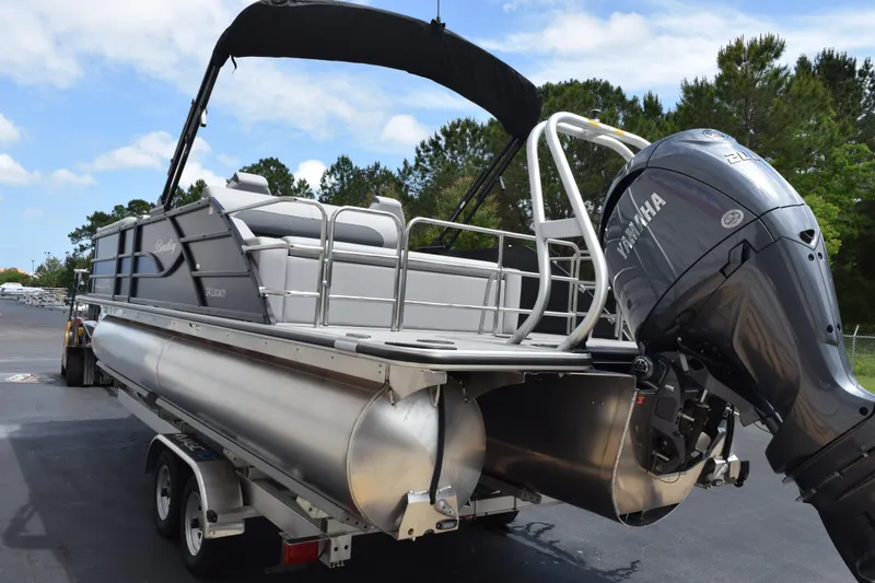Slide: The Image of 2026 Bentley Pontoons Legacy 243 Swingback with Yamaha engine on trailer, parked outdoors. - 6