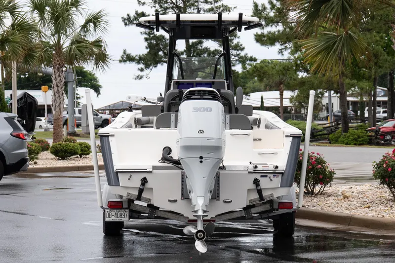 Slide: The Image of 2022 Sea Born LX24 Center Console boat on trailer, parked near palm trees. - 5