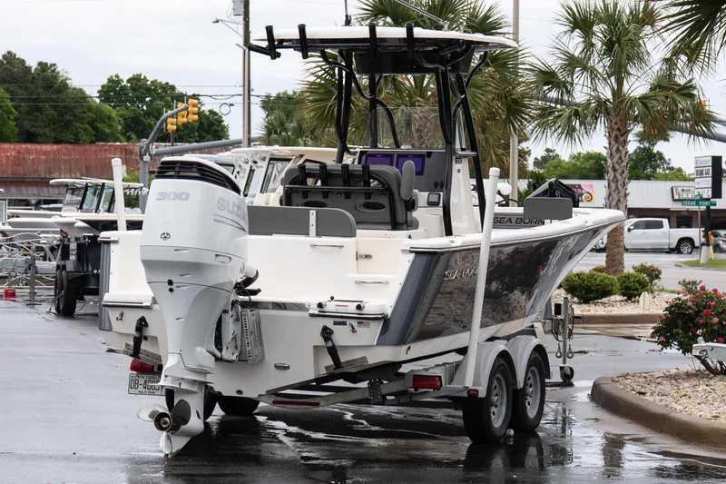 Slide: The Image of 2022 Sea Born LX24 Center Console boat on trailer, featuring Suzuki 300 outboard motor. - 6