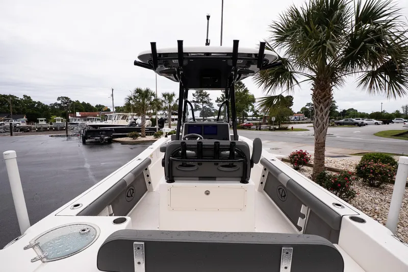 Slide: The Image of 2022 Sea Born LX24 Center Console boat in a parking lot with palm trees. - 7