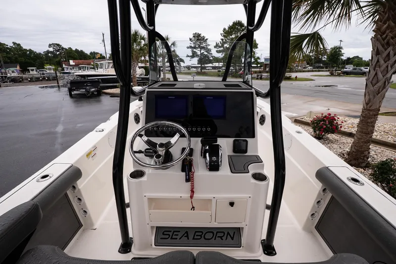 Slide: The Image of 2022 Sea Born LX24 Center Console boat interior with steering wheel and controls. - 8