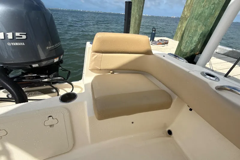 Slide: The Image of 2021 Scout 195 Sportfish boat with Yamaha 115 engine, docked by the water. - 13