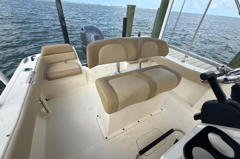 Slide: The Image of 2021 Scout 195 Sportfish boat interior with tan seating and ocean view. - 14