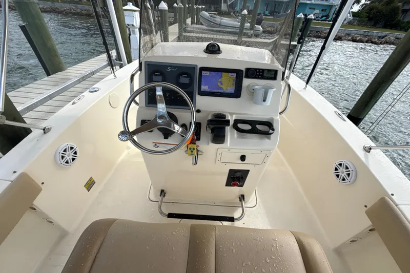 Slide: The Image of 2021 Scout 195 Sportfish boat cockpit with steering wheel and navigation system. - 5