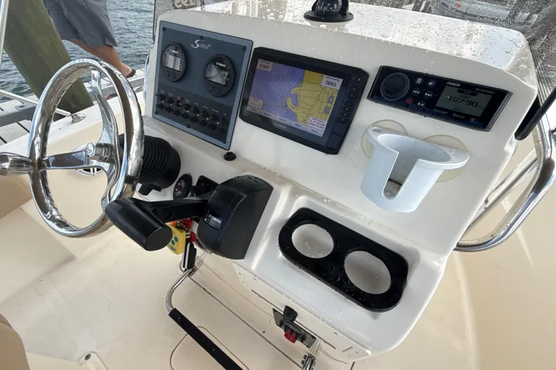 Slide: The Image of 2021 Scout 195 Sportfish boat dashboard with navigation and control systems. - 6