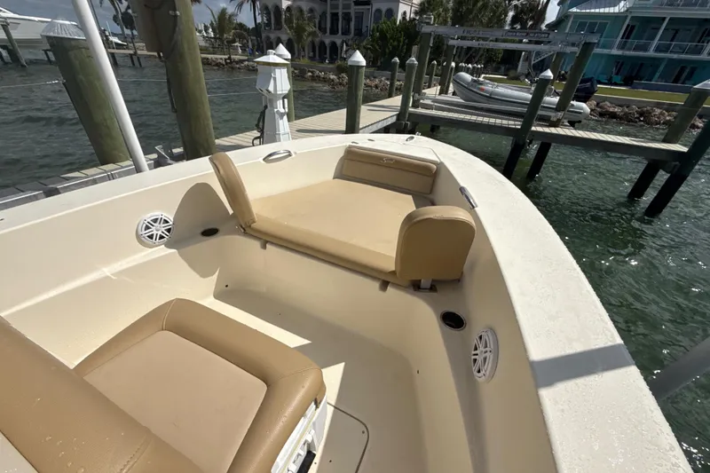 Slide: The Image of 2021 Scout 195 Sportfish boat with tan seating at a dockside location. - 8