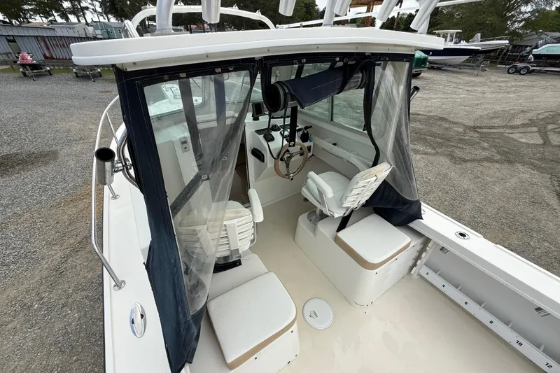 Slide: The Image of 2013 Steiger Craft 23 Miami boat interior with helm and seating area. - 10