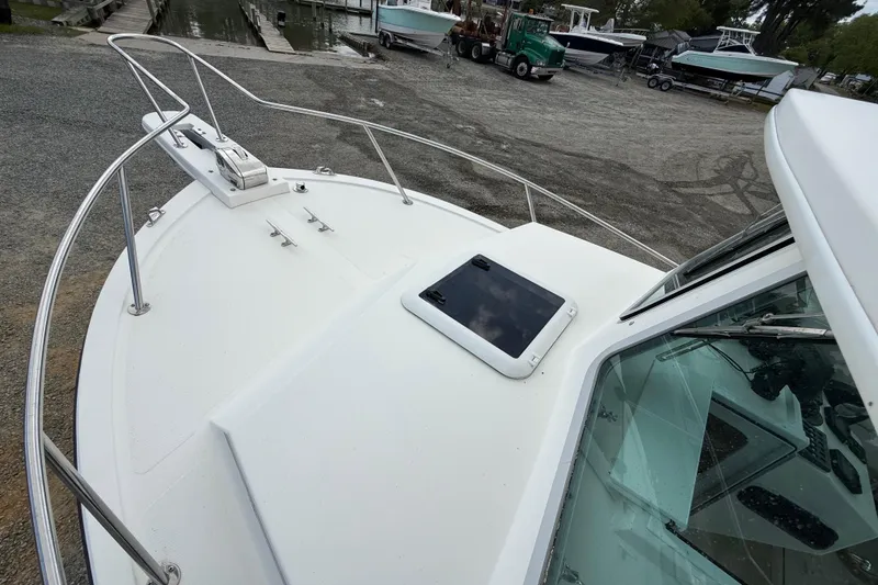 Slide: The Image of 2013 Steiger Craft 23 Miami boat deck with hatch and railing at marina. - 12