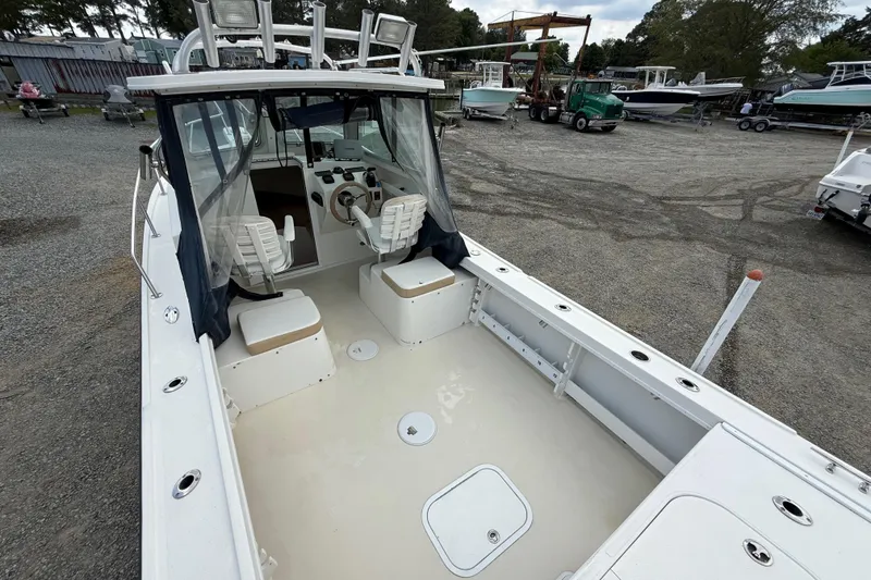 Slide: The Image of 2013 Steiger Craft 23 Miami boat interior with seating and steering wheel. - 13