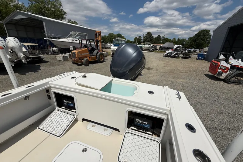 Slide: The Image of 2013 Steiger Craft 23 Miami boat in a marina with equipment and vehicles. - 17