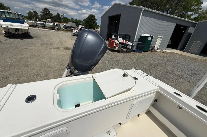 Slide: The Image of 2013 Steiger Craft 23 Miami boat with open storage compartment and outboard motor. - 18