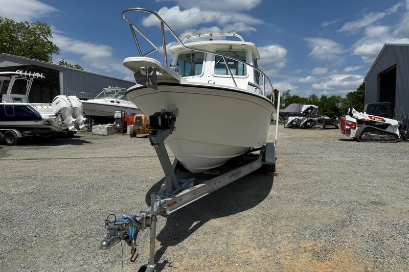 Slide: The Image of 2013 Steiger Craft 23 Miami boat on trailer in outdoor storage area. - 23