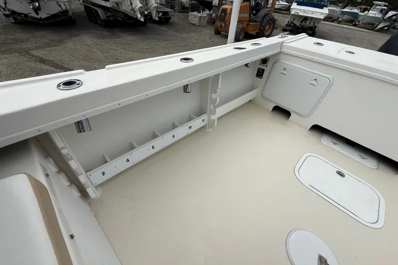 Slide: The Image of 2013 Steiger Craft 23 Miami boat interior with rod holders and storage compartments. - 6