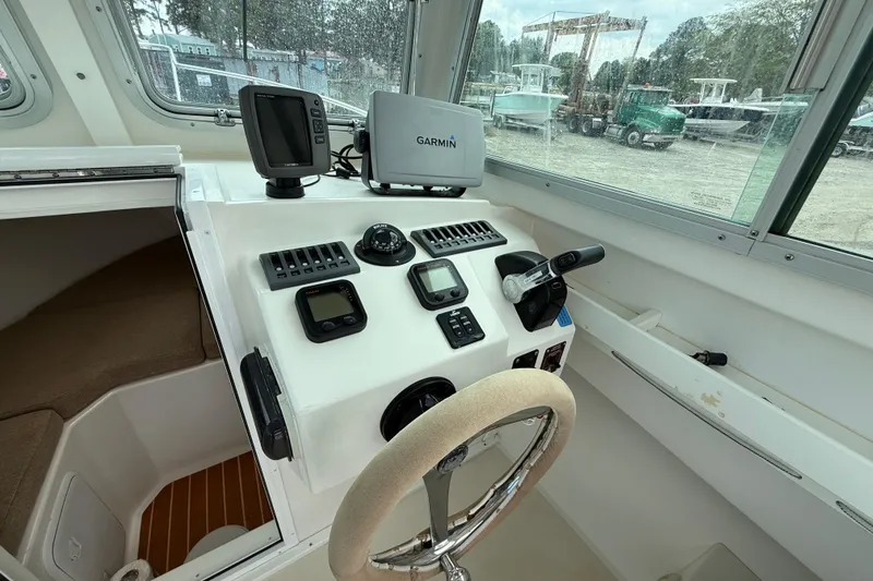 Slide: The Image of Steiger Craft 23 Miami 2013 boat cockpit with Garmin navigation system and steering wheel. - 7