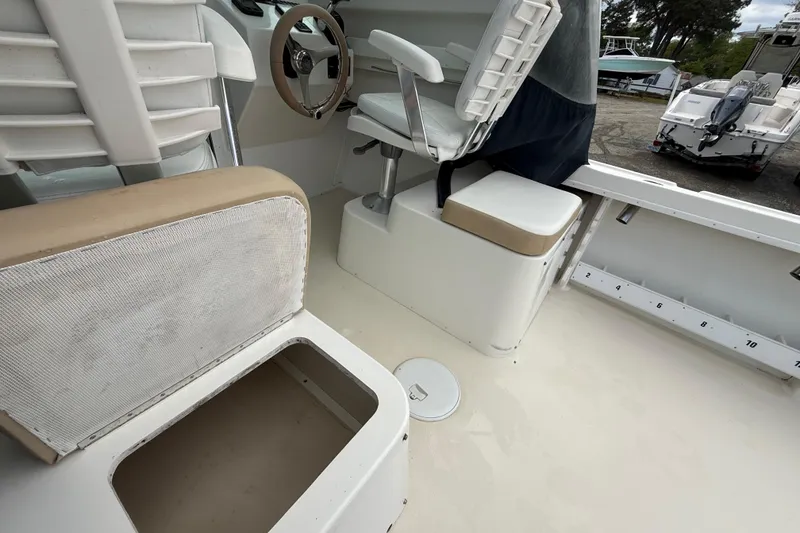 Slide: The Image of 2013 Steiger Craft 23 Miami boat interior with seating and storage compartments. - 8