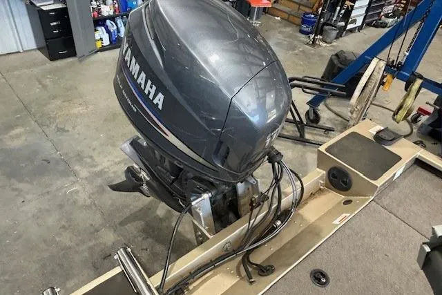 Slide: The Image of 2011 G3 Eagle 180 boat with Yamaha outboard motor in a workshop setting. - 11
