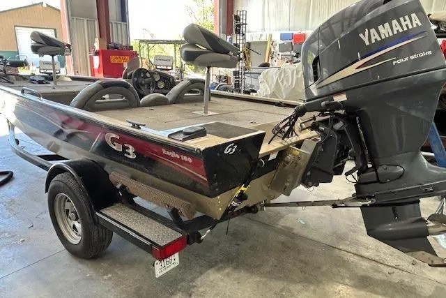 Slide: The Image of 2011 G3 Eagle 180 boat with Yamaha four-stroke engine in a garage setting. - 12