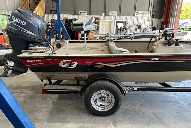 Slide: The Image of 2011 G3 Eagle 180 boat with Yamaha motor in a workshop setting. - 18