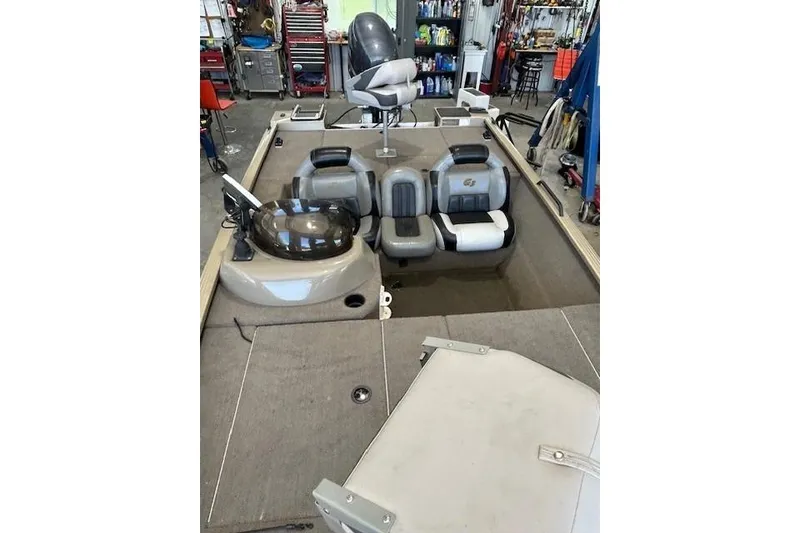 Slide: The Image of 2011 G3 Eagle 180 boat interior with seating and control panel in a workshop. - 7