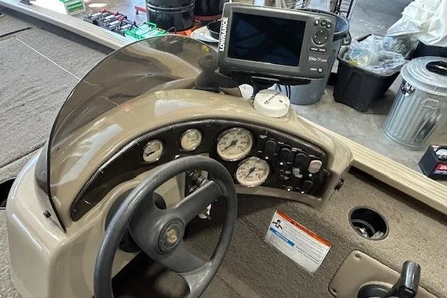 Slide: The Image of Cockpit of 2011 G3 Eagle 180 boat with steering wheel and fishfinder. - 8