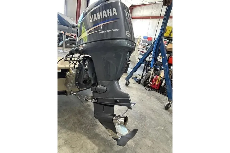 Slide: The Image of Yamaha four-stroke outboard motor on 2011 G3 Eagle 180 boat in a workshop. - 9