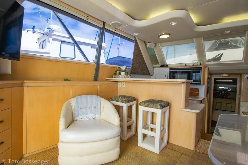Slide: The Image of Interior of 1993 Tiara Yachts 4300 Convertible, featuring seating and modern amenities. - 10