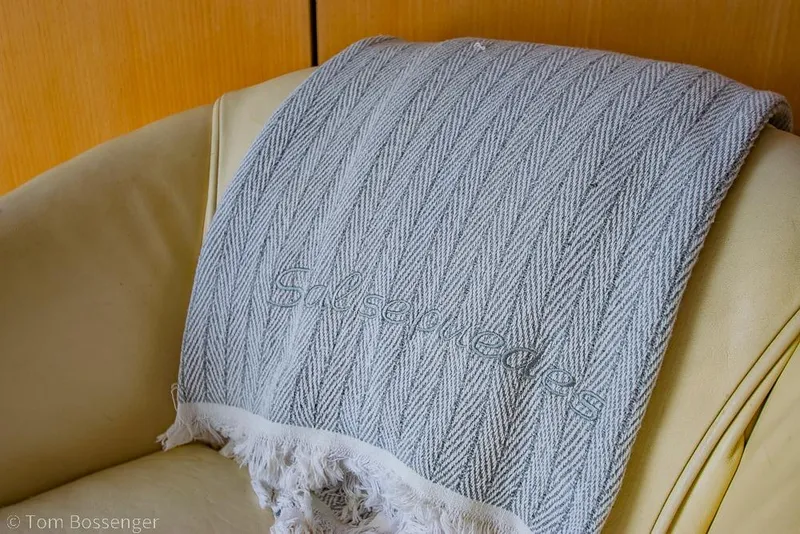 Slide: The Image of Gray textured blanket on a beige leather seat inside a 1993 Tiara Yachts 4300 Convertible. - 13