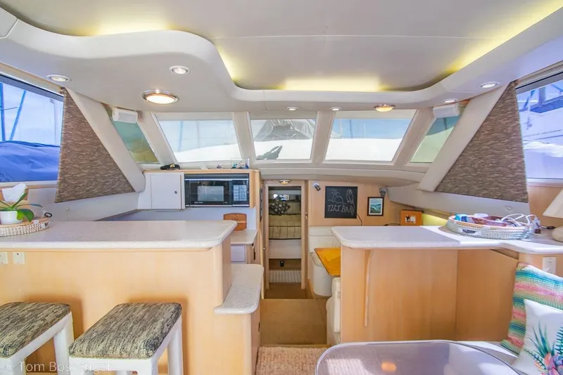 Slide: The Image of Interior of 1993 Tiara Yachts 4300 Convertible, featuring modern kitchen and seating area. - 14