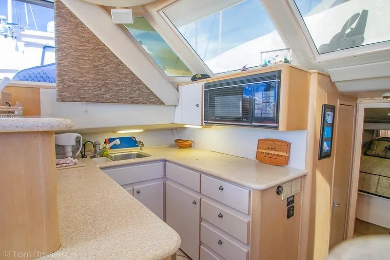 Slide: The Image of Interior of 1993 Tiara Yachts 4300 Convertible, featuring a modern kitchen area. - 15
