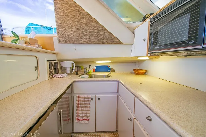 Slide: The Image of 1993 Tiara Yachts 4300 Convertible kitchen with modern appliances and ample counter space. - 16