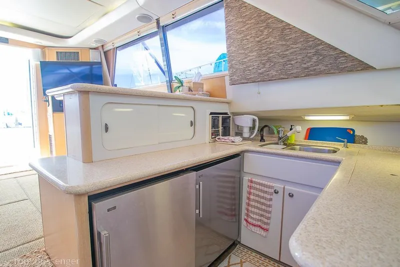 Slide: The Image of Interior of 1993 Tiara Yachts 4300 Convertible, featuring a modern kitchen area. - 17