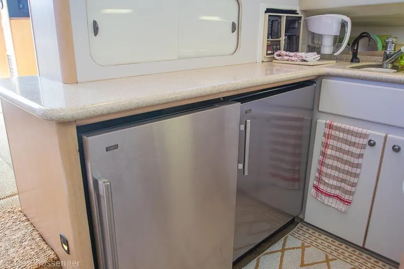 Slide: The Image of Kitchen area of a 1993 Tiara Yachts 4300 Convertible with modern appliances. - 18