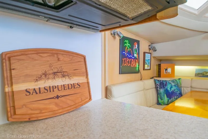 Slide: The Image of Interior of 1993 Tiara Yachts 4300 Convertible with decorative wooden sign and colorful artwork. - 20