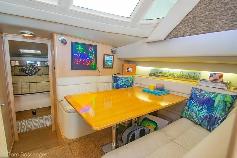 Slide: The Image of Interior of 1993 Tiara Yachts 4300 Convertible with cozy dining area and vibrant decor. - 21