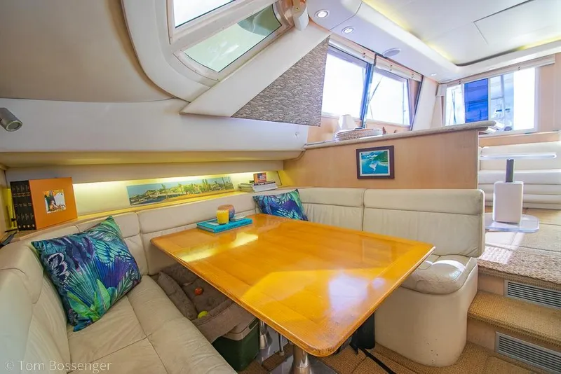 Slide: The Image of Interior of 1993 Tiara Yachts 4300 Convertible with cozy dining area and vibrant decor. - 22