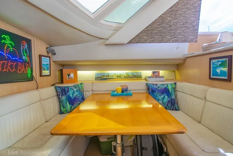 Slide: The Image of Interior of 1993 Tiara Yachts 4300 Convertible with cozy dining area and tropical decor. - 23