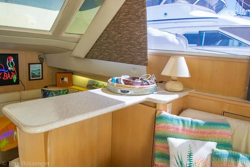 Slide: The Image of Interior of a 1993 Tiara Yachts 4300 Convertible with cozy seating and decor. - 24