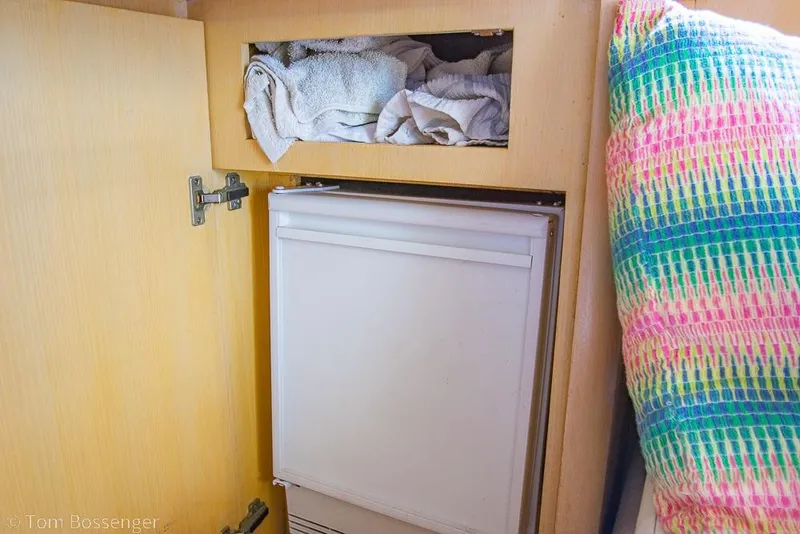 Slide: The Image of Cabinet with towels and fridge in 1993 Tiara Yachts 4300 Convertible interior. - 25