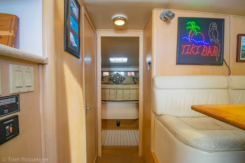 Slide: The Image of Interior of 1993 Tiara Yachts 4300 Convertible with cozy seating and decor. - 26