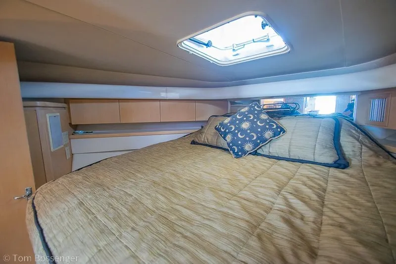 Slide: The Image of Cozy cabin interior of 1993 Tiara Yachts 4300 Convertible with skylight and decorative pillow. - 28