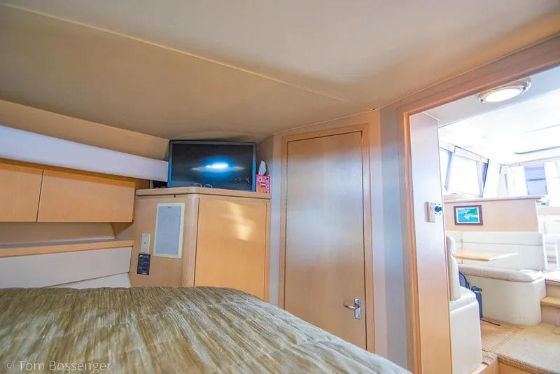 Slide: The Image of Interior of 1993 Tiara Yachts 4300 Convertible, featuring cozy cabin and modern amenities. - 29